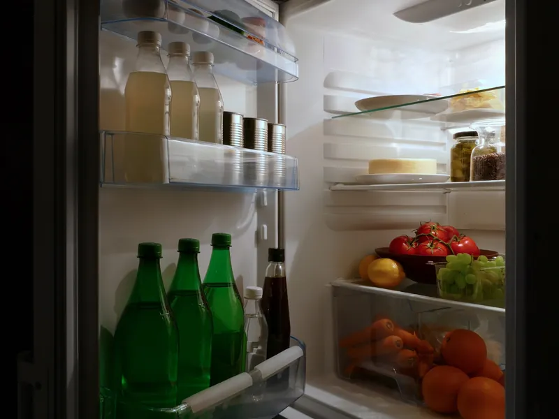 Open refrigerator stocked with food and drinks